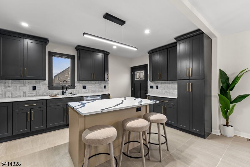79 3rd Street Somerville, NJ 08876 - Photo 3 of 20 a kitchen with stainless steel appliances a sink a stove a refrigerator and chairs