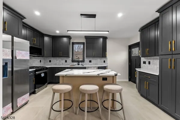 a kitchen with cabinets a counter and chairs