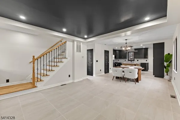 a large room with lots of white furniture