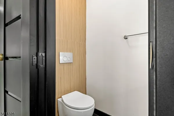a white toilet sitting next to a shower
