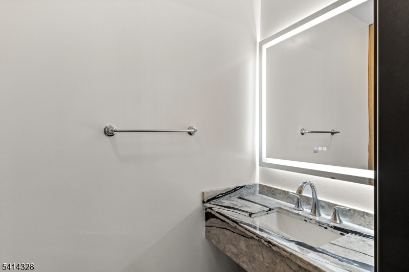 79 3rd Street Somerville, NJ 08876 - Photo 8 of 20 a bathroom with a granite countertop sink and a mirror