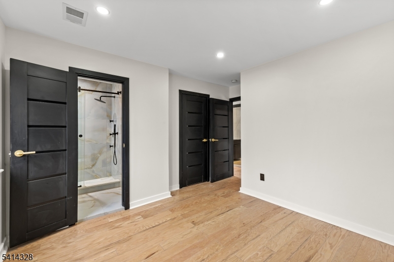 79 3rd Street Somerville, NJ 08876 - Photo 10 of 20 a big room with closet and wooden floor