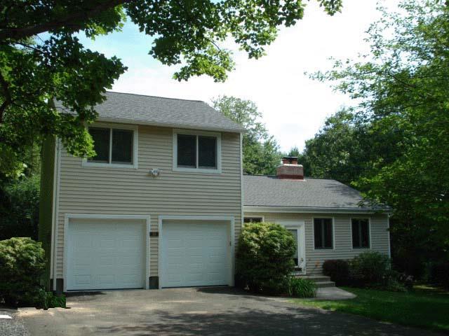 a house that has a tree in front of the house
