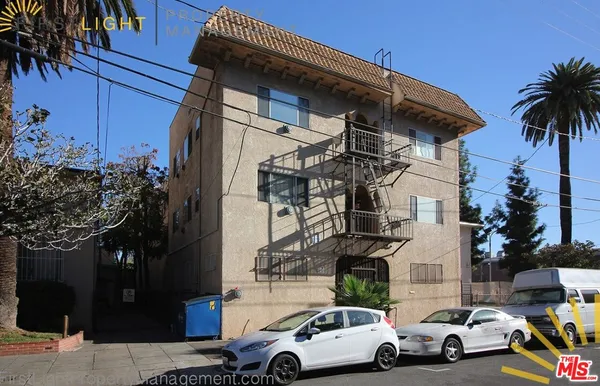 a view of cars parked in front of a house