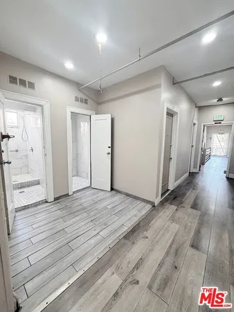 a view of hallway with wooden floor