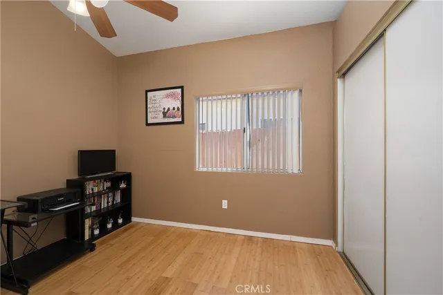 a view of a workspace with furniture and wooden floor
