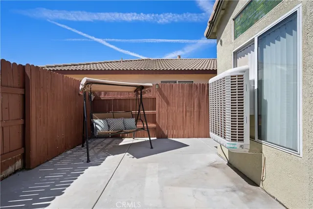 a balcony with chairs and wooden floor