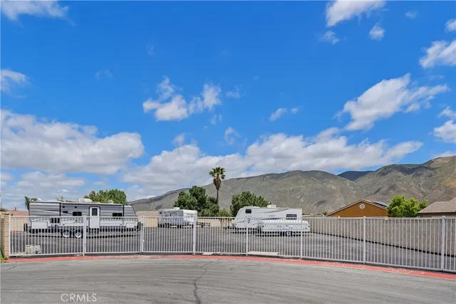a view of a sign board with flower plants in front of main door