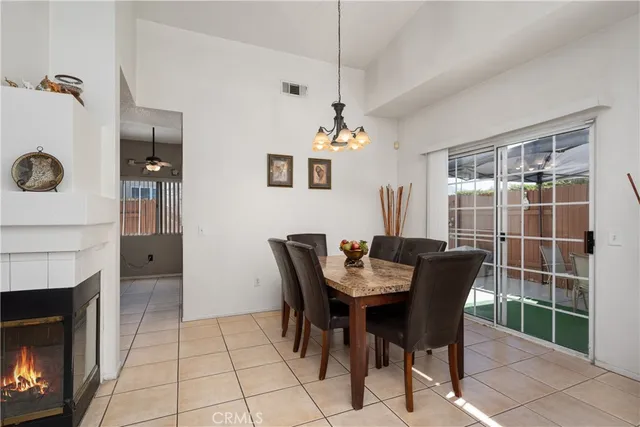 a view of a dining room with furniture and chandelier