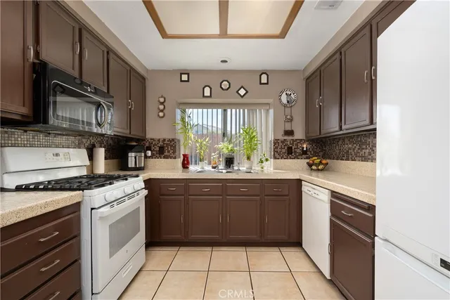 a kitchen with stainless steel appliances granite countertop a stove sink and cabinets