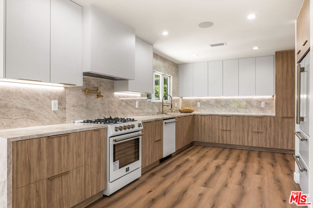 266 Mabery Road Santa Monica, CA 90402 - Photo 18 of 47 a kitchen with stainless steel appliances granite countertop a stove a sink and a refrigerator