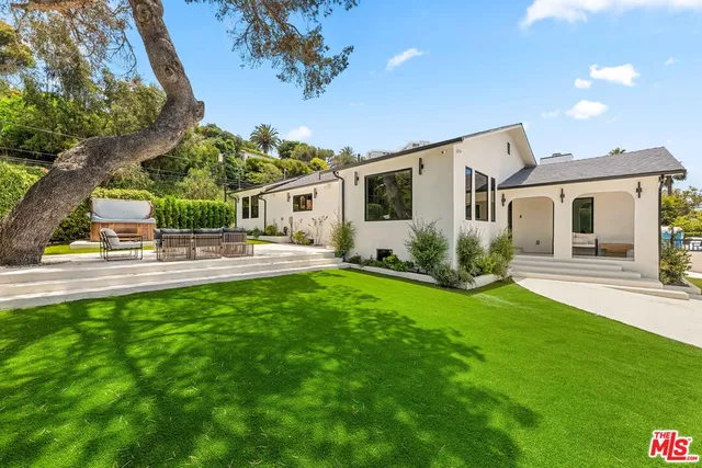 a front view of house with yard and outdoor seating