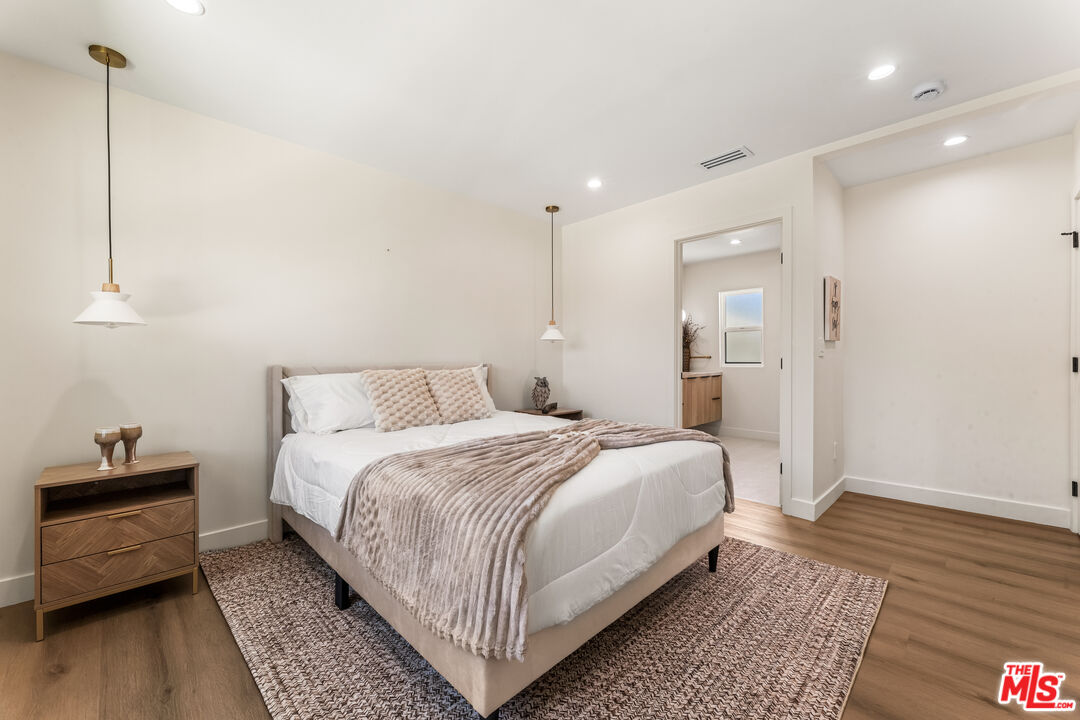 266 Mabery Road Santa Monica, CA 90402 - Photo 23 of 47 a bedroom with a bed and wooden floor