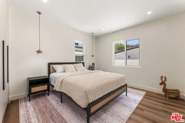 a bedroom with a bed and a painting on the wall