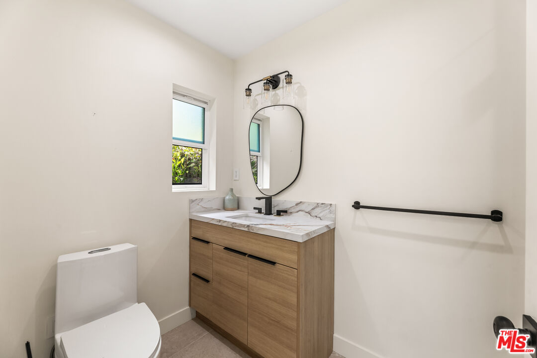 266 Mabery Road Santa Monica, CA 90402 - Photo 40 of 47 a bathroom with a toilet sink vanity and mirror