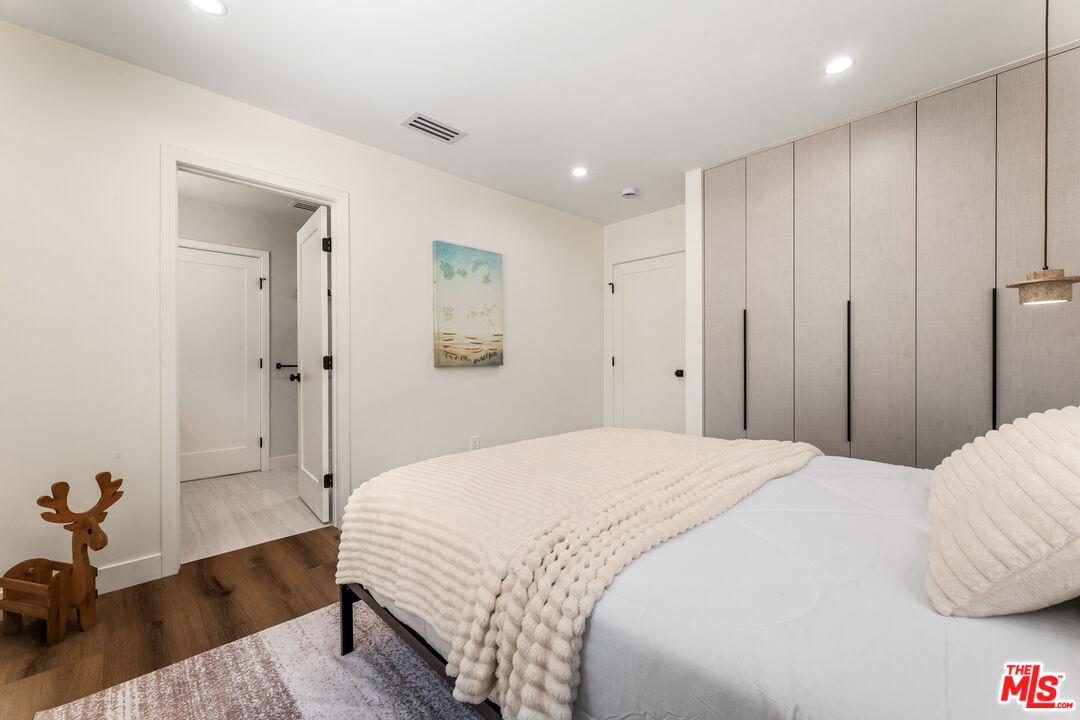 266 Mabery Road Santa Monica, CA 90402 - Photo 10 of 47 a bedroom with a bed and wooden floor