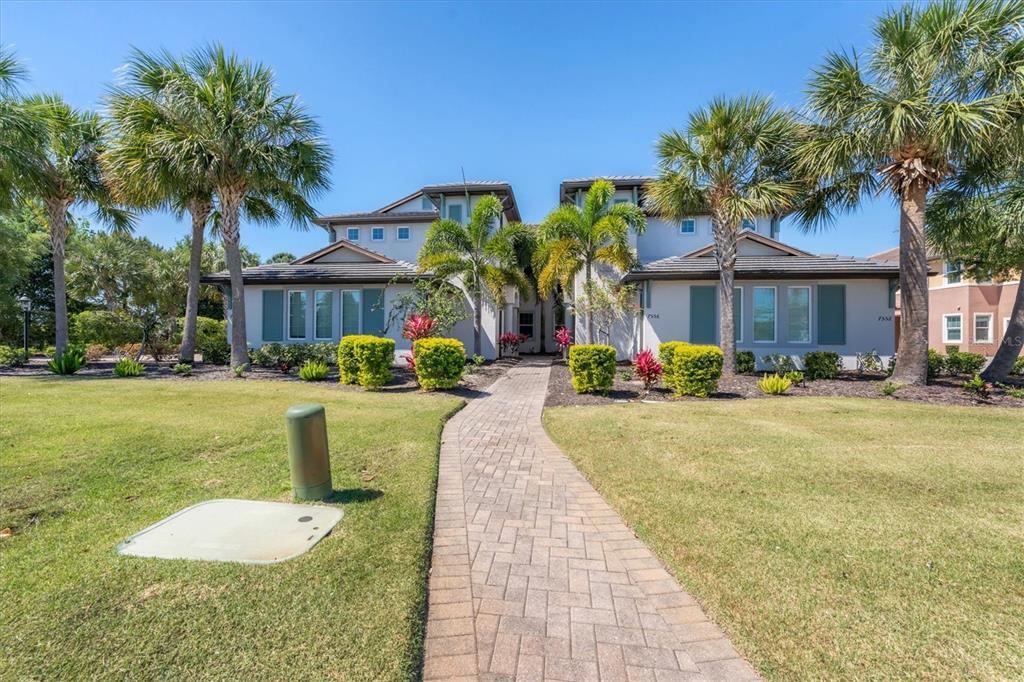 7564 Divot Loop Bradenton, FL 34202 - Photo 1 of 30 a swimming pool with outdoor seating and yard