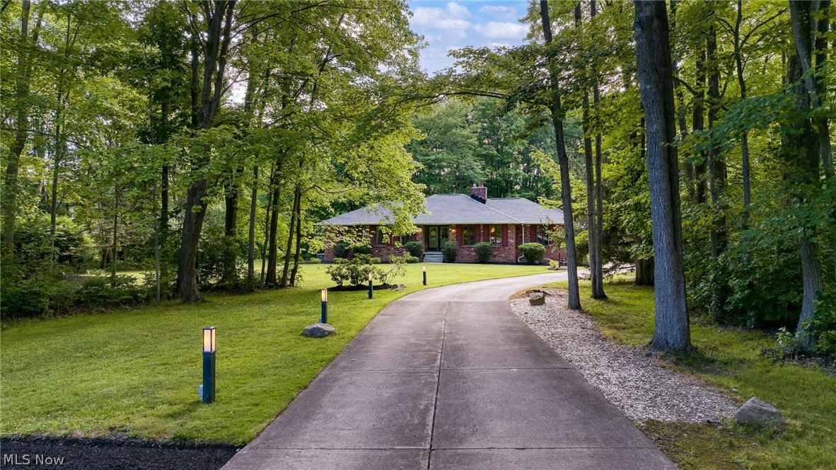 4830 Som Center Road Moreland Hills, OH 44022 - Photo 48 of 48 Living on the Fringe — Borrow the View, Skip the Rules
Some homes simply stop you in your tracks. This stunning ranch, offering 4,000+ sq ft of total living space w/ mid-century modern soul, is one of them. Set against mature trees & rolling greenery just off the fairway, w/ Chagrin Valley CC as a scenic neighbor, it commands attention from the moment you arrive. A long, private driveway winds gracefully thru beautifully landscaped grounds, comfortably accommodating up to 15 cars for grand, elegant entertaining.
As you enter, the soaring cathedral great rm dazzles w/ a dramatic wall of windows, skylights, & slider, flooding the space w/ nat light. A rare touch of luxury: an indoor grill just off the great rm gives joy to those who love grilling year-round, rain or snow, w/o ever leaving the comfort of home. The eat-in kitchen, formal dining rm, & living rm offer gracious spaces for everyday living, flowing easily into the lounge, where a striking stone frplc & wet bar create a warm, sociable gathering s
