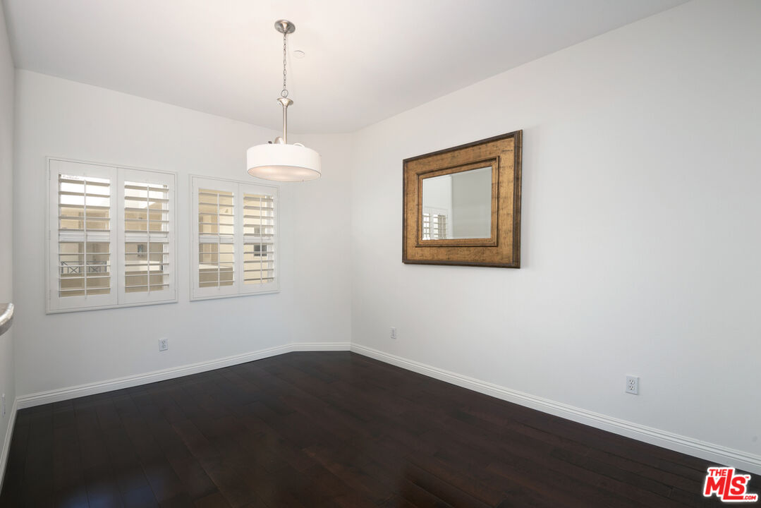 4400 Cartwright Avenue, Unit 201 Toluca Lake, CA 91602 - Photo 11 of 30 a view of an empty room with wooden floor and a window