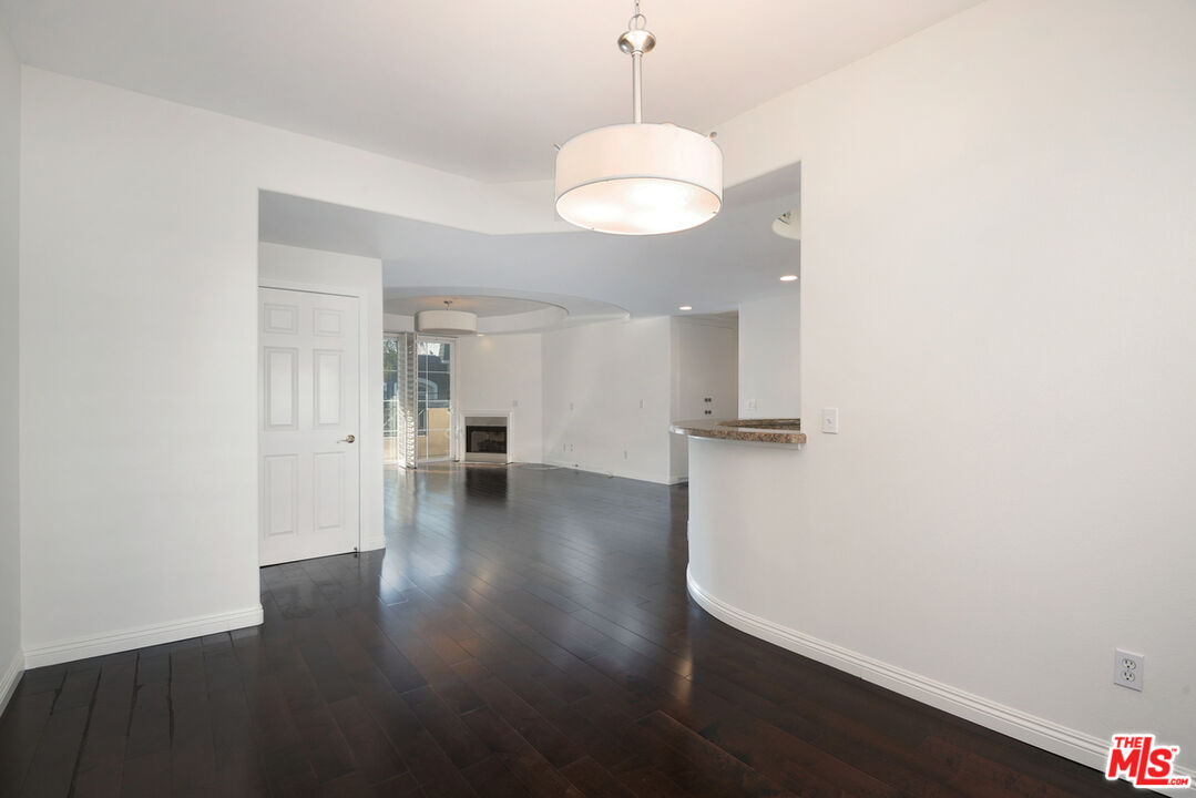 4400 Cartwright Avenue, Unit 201 Toluca Lake, CA 91602 - Photo 12 of 30 a view of a room with wooden floor and kitchen view