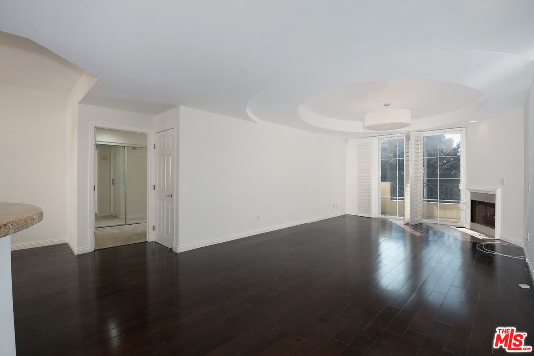 4400 Cartwright Avenue, Unit 201 Toluca Lake, CA 91602 - Photo 15 of 30 a view of an empty room with wooden floor and a window
