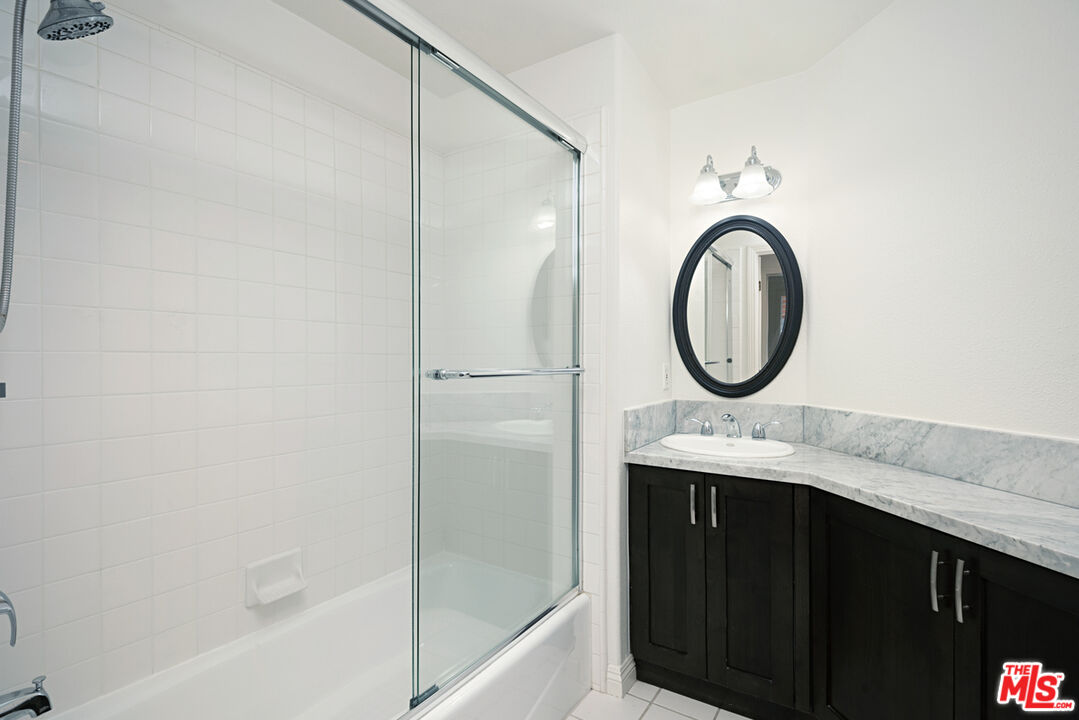 4400 Cartwright Avenue, Unit 201 Toluca Lake, CA 91602 - Photo 19 of 30 a bathroom with a granite countertop sink a toilet and a bathtub