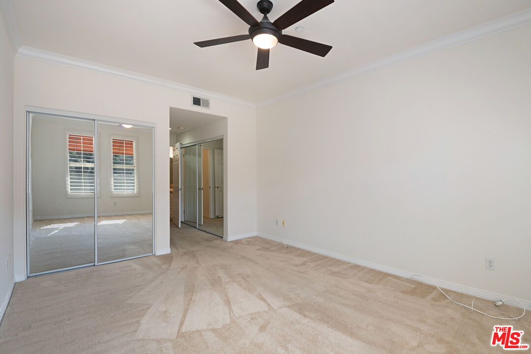 4400 Cartwright Avenue, Unit 201 Toluca Lake, CA 91602 - Photo 21 of 30 a view of an empty room with closet and a chandelier fan