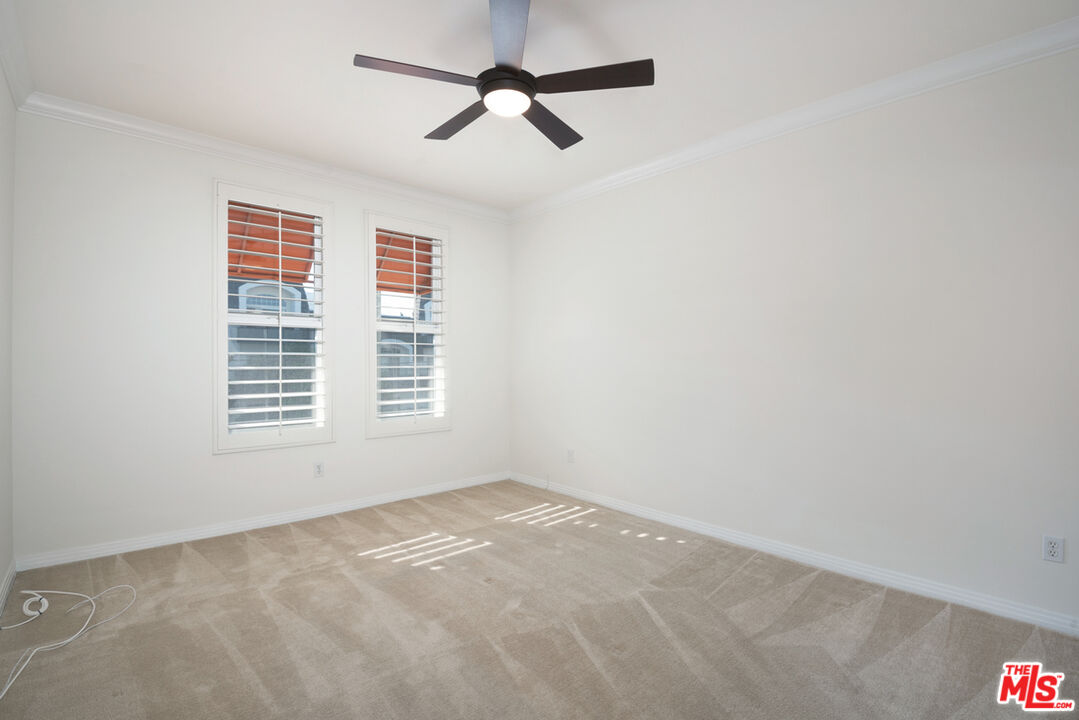 4400 Cartwright Avenue, Unit 201 Toluca Lake, CA 91602 - Photo 23 of 30 a view of a livingroom with a ceiling fan and window