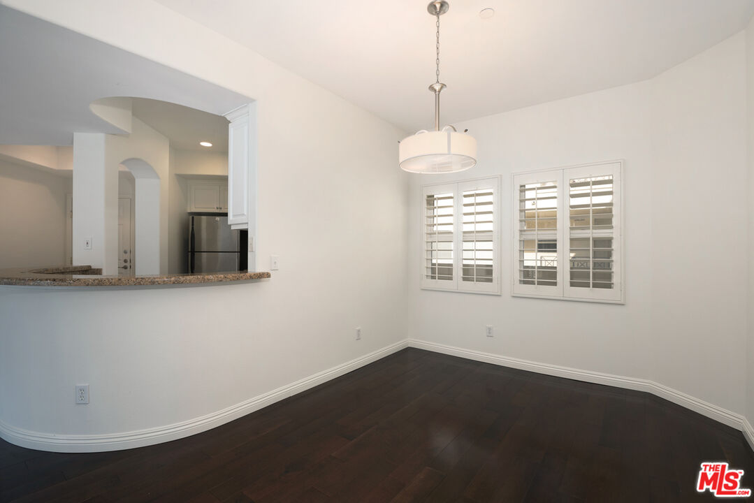 4400 Cartwright Avenue, Unit 201 Toluca Lake, CA 91602 - Photo 10 of 30 a view of a room with wooden floor and windows