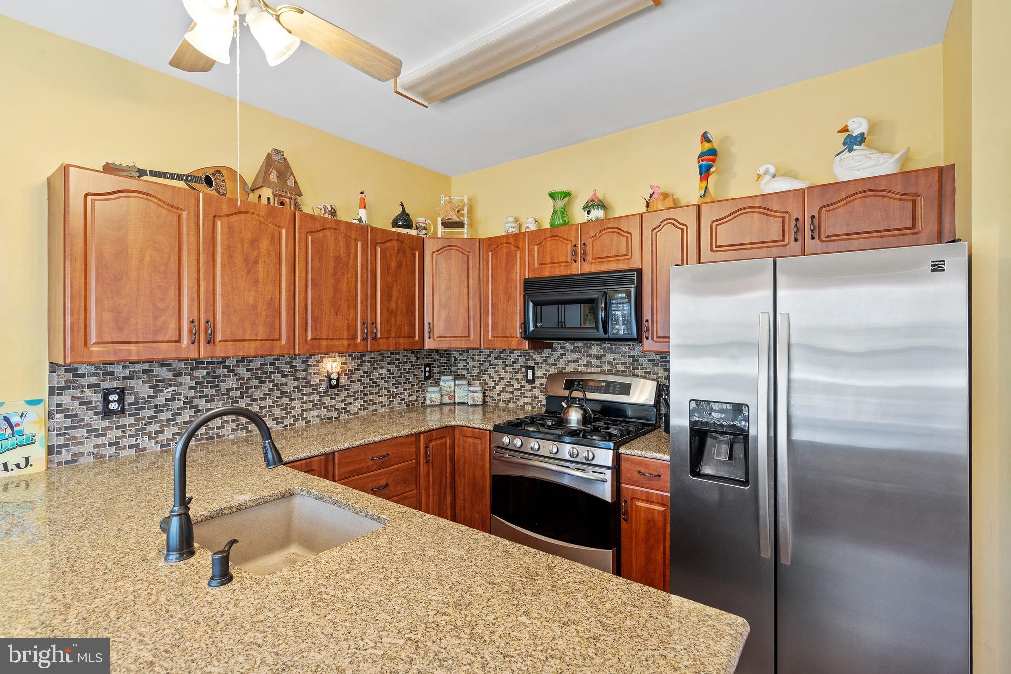 10 Hampton Road Manahawkin, NJ 08050 - Photo 11 of 36 a kitchen with granite countertop a sink stainless steel appliances and a counter top space