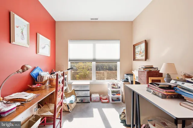 a spacious bedroom with a bed a dresser and flat screen tv