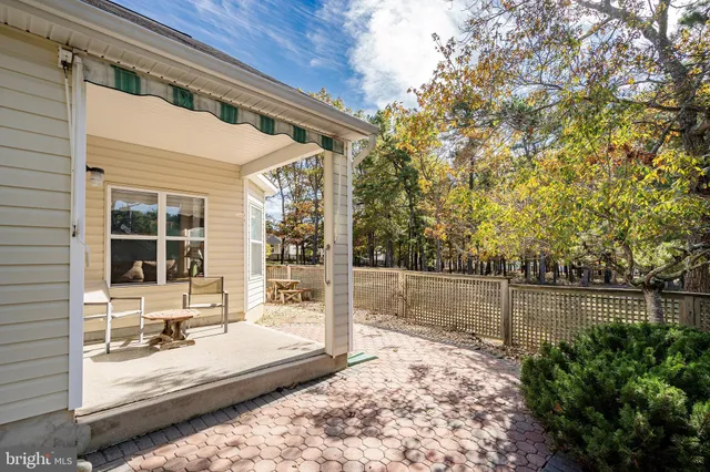 a view of a house with a backyard and a tree