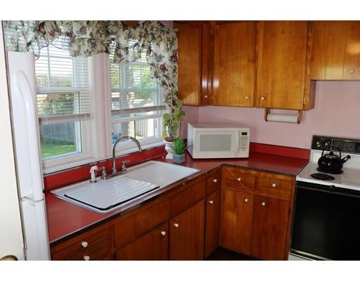 82 Edgewater Road Hull, MA 02045 - Photo 9 of 25 a kitchen with a sink cabinets and a stove