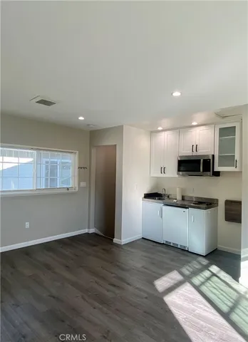 a kitchen with granite countertop a stove and a sink
