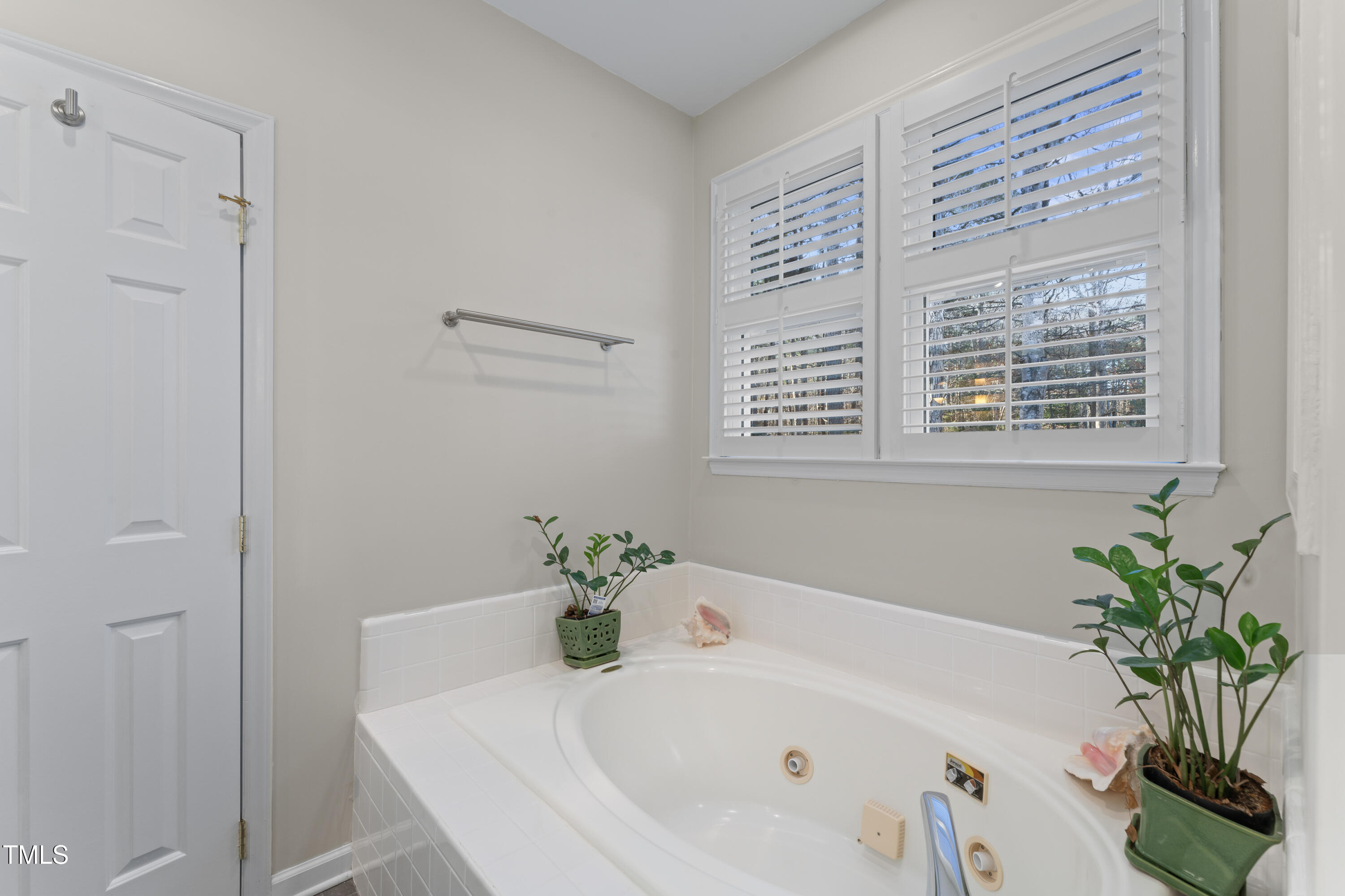 111 Legacy Lane Durham, NC 27713 - Photo 15 of 24 a white bath tub sitting in a bathroom next to a window