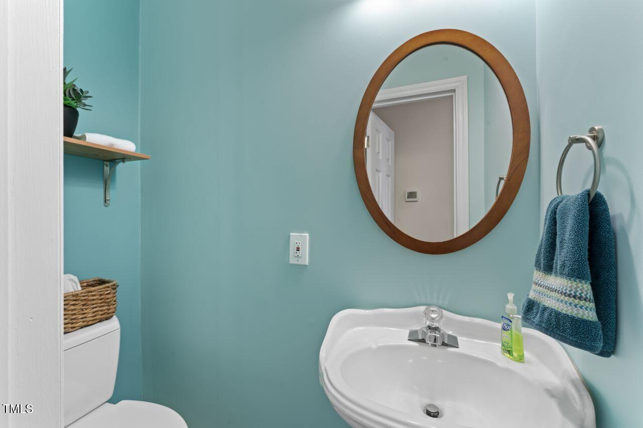 111 Legacy Lane Durham, NC 27713 - Photo 19 of 24 a bathroom with a sink a mirror and a toilet