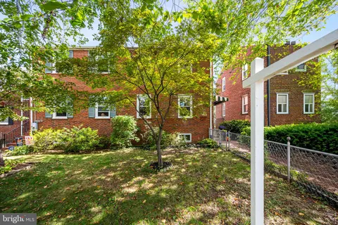 a view of a house with a tree in the yard