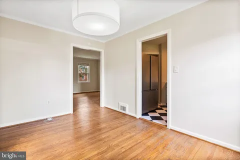 an empty room with wooden floor and closet