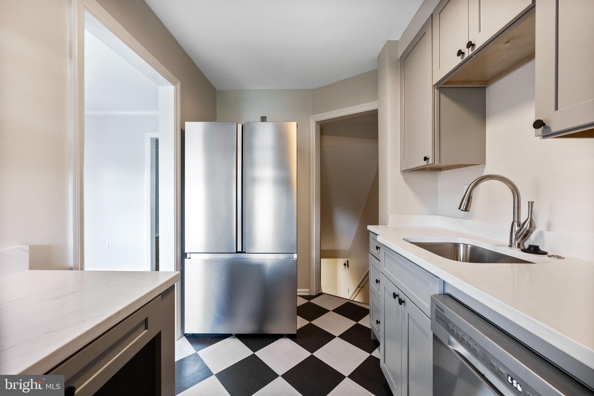 4937 11th Street Northeast Washington, DC 20017 - Photo 10 of 28 a kitchen with a refrigerator sink and cabinets