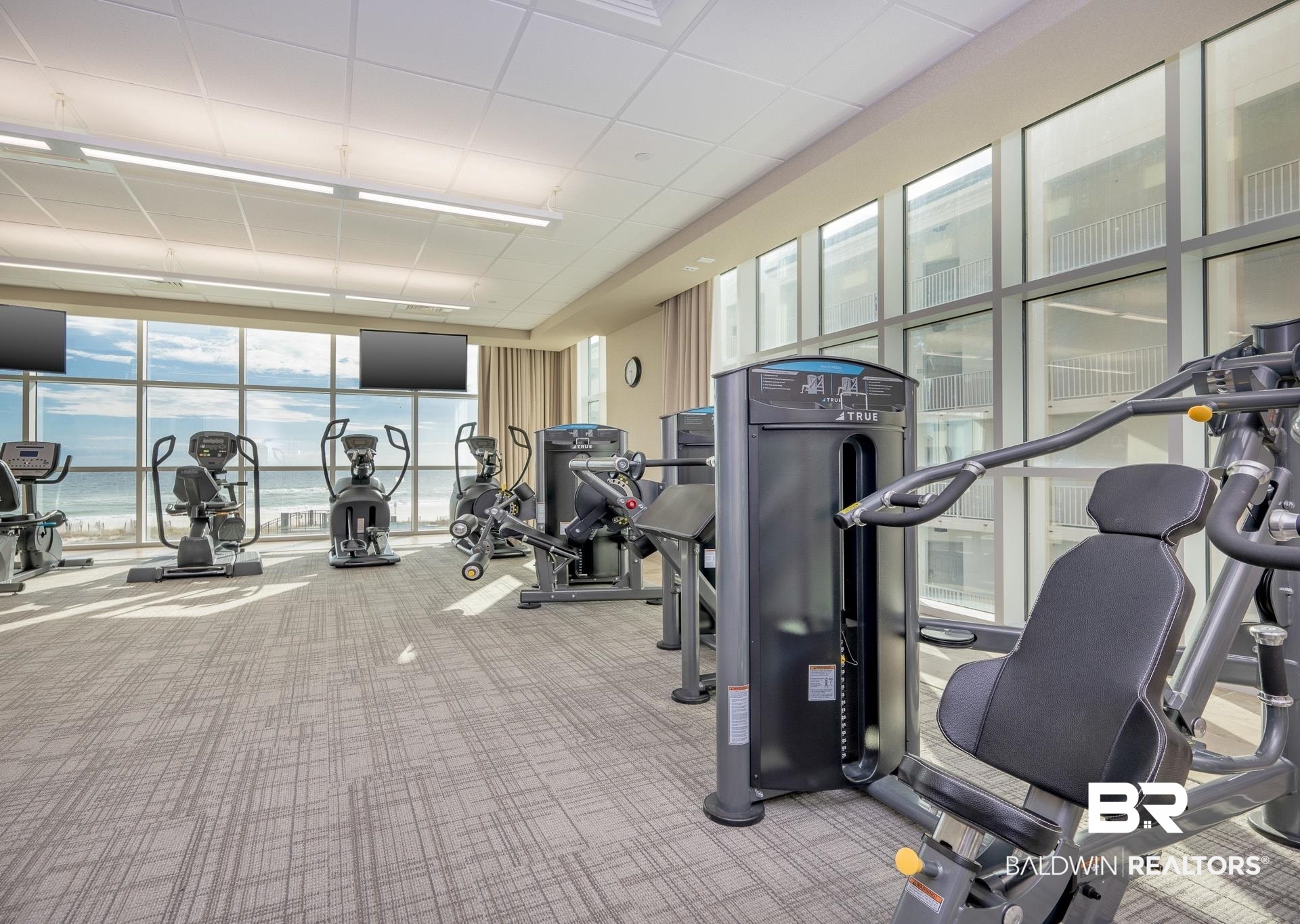 23008 Perdido Beach Boulevard, Unit 506 Orange Beach, AL 36561 - Photo 44 of 48 Exercise room featuring floor to ceiling windows, a drop ceiling, and carpet