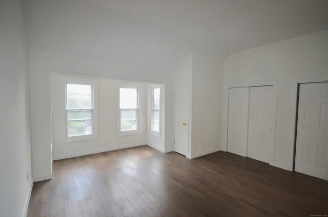 a view of wooden floor and windows in a room