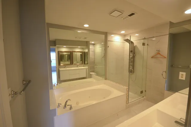 a bathroom with a bathtub and shower