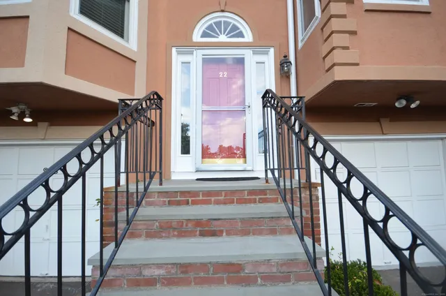 a view of staircase with railing and a chandelier