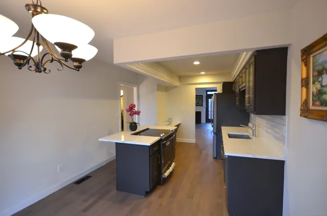 a kitchen with a sink appliances and cabinets