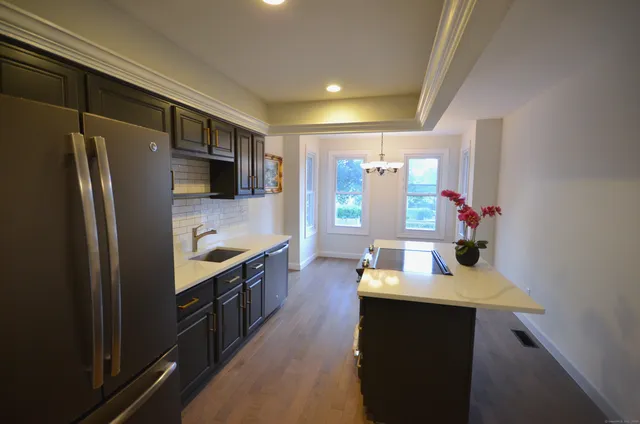 a kitchen with stainless steel appliances a sink stove and refrigerator