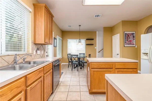 a kitchen with stainless steel appliances a stove microwave and a sink