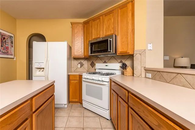 a living room with furniture a fireplace and a window