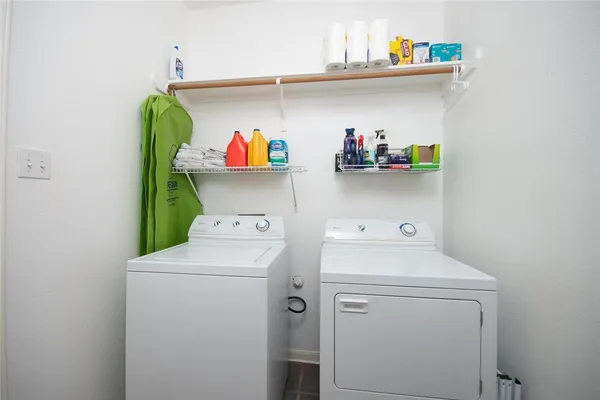 a view of a house with a yard and tree