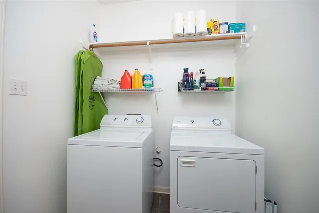 a view of a house with a yard and tree