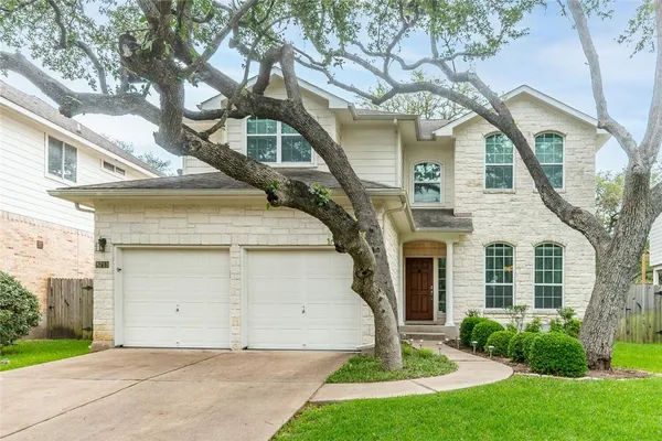 a front view of a house with a yard and garage